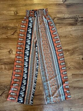 Alloy Apparel Tall Smock Waist Flowy Pants in a navy paisley and elephant print.